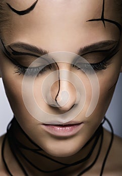 Beautiful cyber girl with linear black makeup