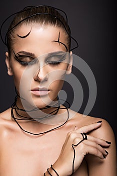 Beautiful cyber girl with linear black makeup