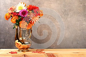 Beautiful dahlia flowers in a vase, abstract floral arrangement, autumn background with space for text, minimal holiday concept,