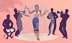 Beautiful dancer playing maracas and four latin musicians playing bongos, trumpet, claves and trombone photo