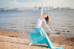 Beautiful dancer poses on the beach