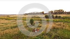 Beautiful dancing girl in the field - the evening dance in a circle - aero