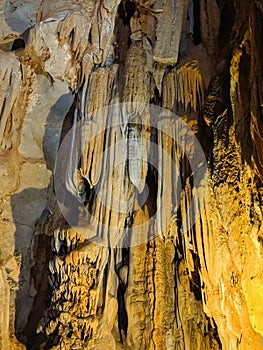 Beautiful dark cave interior with ancient stalactites and stalagmites