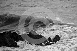 Beautiful dark dramatic toned fine art seascape image of breaking waves on Atlantic Ocean in Devon England