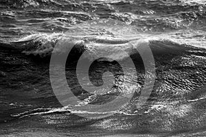 Beautiful dark dramatic toned fine art seascape image of breaking waves on Atlantic Ocean in Devon England