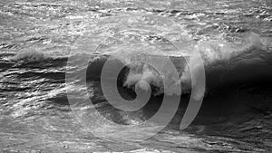 Beautiful dark dramatic toned fine art seascape image of breaking waves on Atlantic Ocean in Devon England