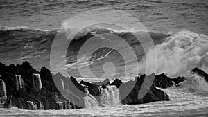 Beautiful dark dramatic toned fine art seascape image of breaking waves on Atlantic Ocean in Devon England