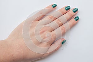 Beautiful dark green nail polish female manicure. spa concept, minimalism. Top view