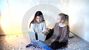 Beautiful dark-haired girl working on laptop at home christmas