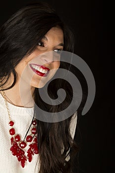 Beautiful dark haired model red lipstick black background