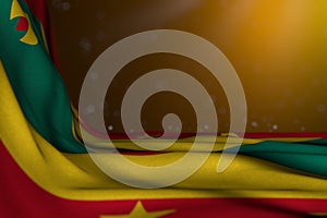 Beautiful dark photo of Grenada flag lying flat in corner on yellow background with soft focus and free space for your content -