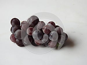 Beautiful dark red and black color grape fruits bunch  on white background