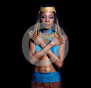 Beautiful dark-skinned girl black woman in the image of the Egyptian queen with red lips bright makeup demonstrates long nails