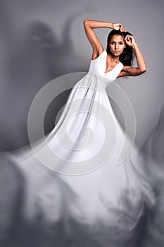 A beautiful dark-skinned woman in a white dress