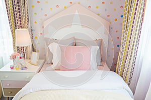 A beautiful daughter bedroom with a pink pillow and pink bed wit