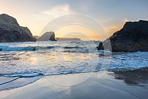 Beautiful dawn landscape over Kynance Cove in Cornwall England with vibrant sky and beautiful turquoise ocean