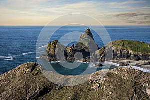 Beautiful dawn landscape over Kynance Cove in Cornwall England with vibrant sky and beautiful turquoise ocean