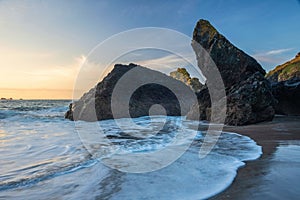 Beautiful dawn landscape over Kynance Cove in Cornwall England with vibrant sky and beautiful turquoise ocean