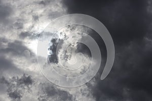 Beautiful day cloudscape view from below of dramatic dramatic grey and white thunder storm clouds on a dark sky background