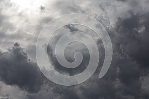 Beautiful day cloudscape view from below of dramatic dramatic grey and white thunder storm clouds on a dark sky background