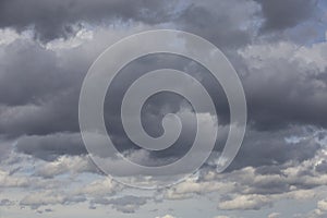 Beautiful day cloudscape view from below of fluffy dramatic white and grey clouds on a deep blue sky background