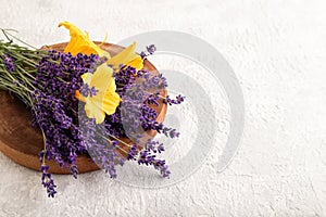 Beautiful day lily and lavender flowers on gray concrete, copy space, side view