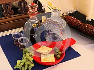 A beautiful decanter, with a red wine to wash down th crackers, grapes and olives.