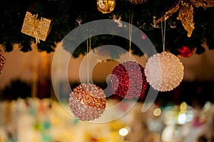 Beautiful decorated Christmas tree background with bauble and xmas ornaments blurred in bokeh home.