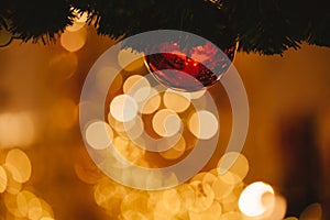 Beautiful decorated Christmas tree background with bauble and xmas ornaments blurred in gold bokeh.