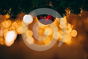 Beautiful decorated Christmas tree background with bauble and xmas ornaments blurred in gold bokeh.