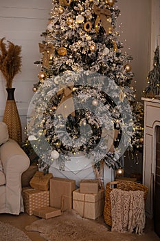 Beautiful decorated Christmas tree with gifts. Cozy xmas Interior living room. gifts in kraft paper