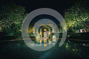 Beautiful decoration of English country style building covered with green creeper plant at night