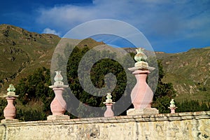 Beautiful decoration on the fence of Santa Ana de Maca Church against the Mountain Range, Colca Canyon, Peru photo