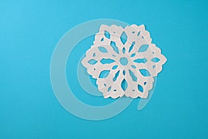 Beautiful decorative snowflakes cutted paper on a blue background. Photo for Christmas and New Year design