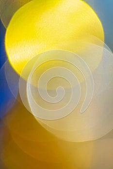 Beautiful defocused abstract blurry bokeh background yellow color. Festive Christmas lens flare photo effect