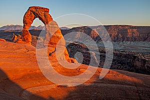 The beautiful Delicate Arch glowing red at sunset in Arches National Park