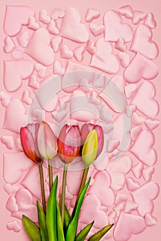 beautiful delicate background of voluminous pink satin hearts of different sizes arranged in the style of puzzles
