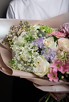 Beautiful delicate bouquet in hand, a bouquet of fresh flowers, handicraft