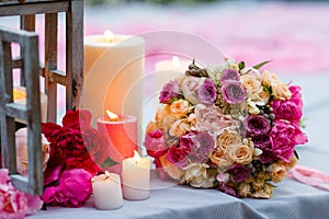 Beautiful, delicate bridal bouquet among decoration with candles and fresh flowers