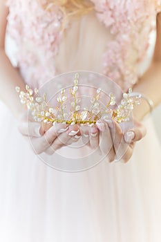 Beautiful delicate crown in the style of fine art at the hands of-girl bride