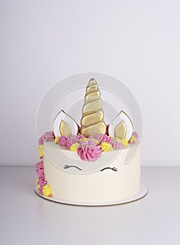 Beautiful delicate unicorn birthday cake on a white table. festive sweet treat