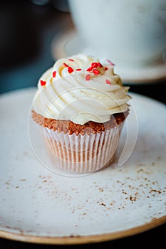 Beautiful delicious cupcakes with pink hearts on the plate