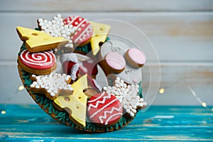 Beautiful and delicious gingerbread with pieces of cheese, mouse, balls for the Christmas tree