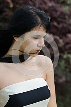 Beautiful depressed girl standing outdoor on strong windy day