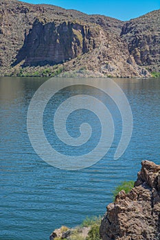 Beautiful desert rock formations line this secluded, Canyon Lake in Tortilla Flat, Tonto National Forest, Arizona