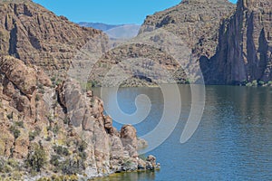 Beautiful desert rock formations line this secluded, Canyon Lake in Tortilla Flat, Tonto National Forest, Arizona