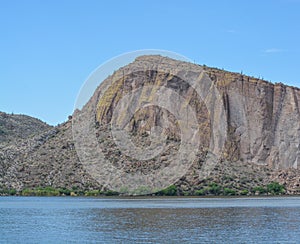 Beautiful desert rock formations line this secluded, Canyon Lake in Tortilla Flat, Tonto National Forest, Arizona