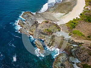 Beautiful deserted and isolated tropical beach surrounded by clear blue ocean (Semeti Beach photo