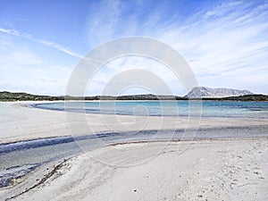 Beautiful deserted white beach in Sardinia, Lu Impostu, with sea in various shades of blue, curves of sand marked by water and the