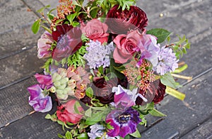 Beautiful designer red purple bouquet of florist with different flowers